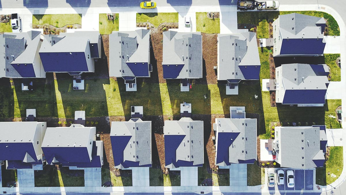 Aerial view of a neighborhood with houses spaced evenly and designed similarly